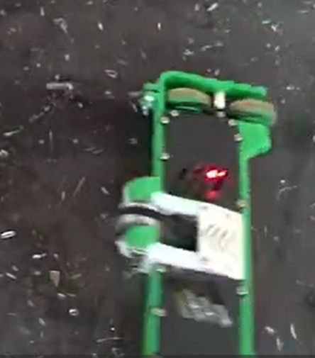 Overhead view of the robot from one end, wheels inside the green bumper.